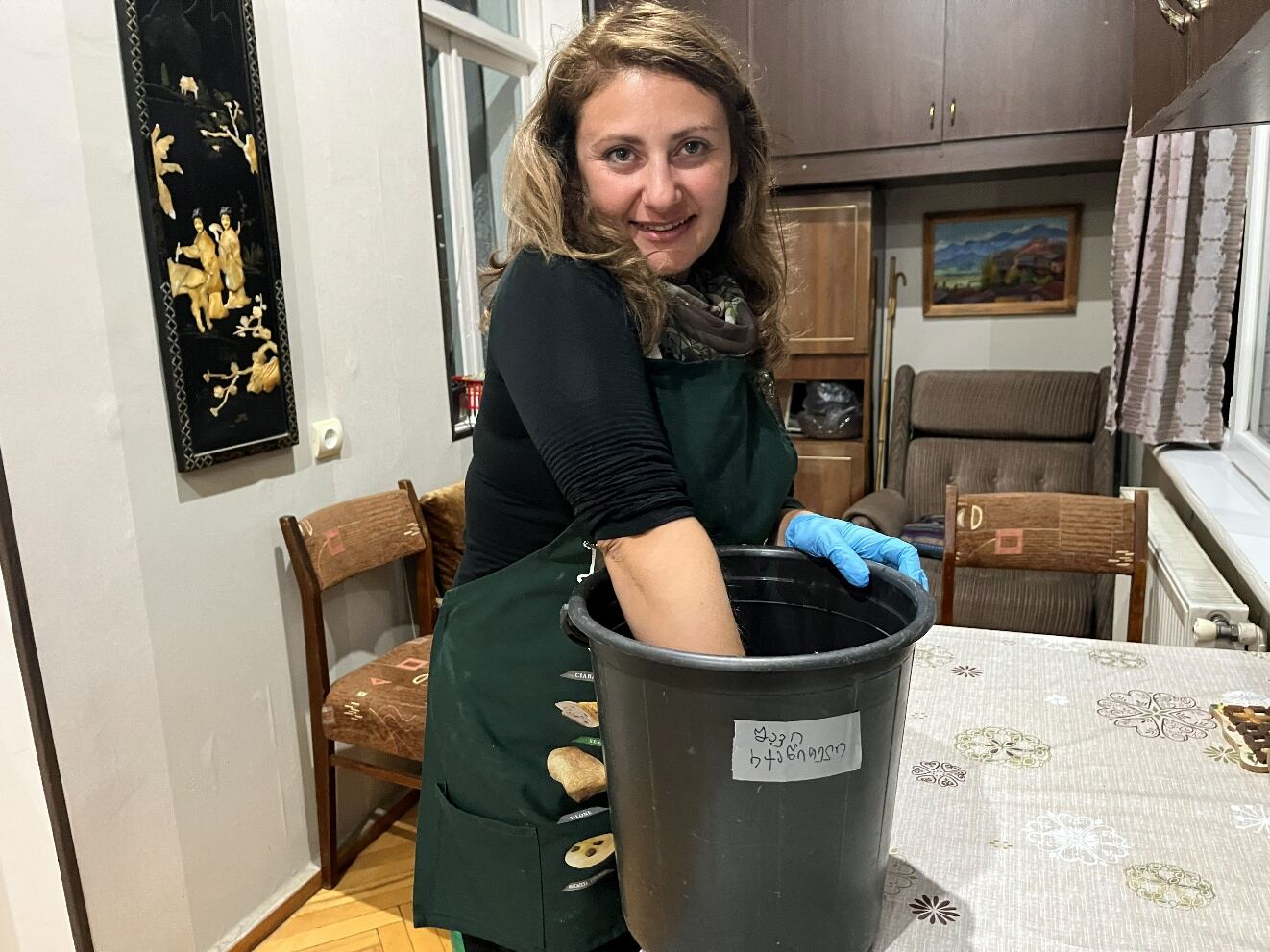 Pressing grapes by hand in a bucket at home