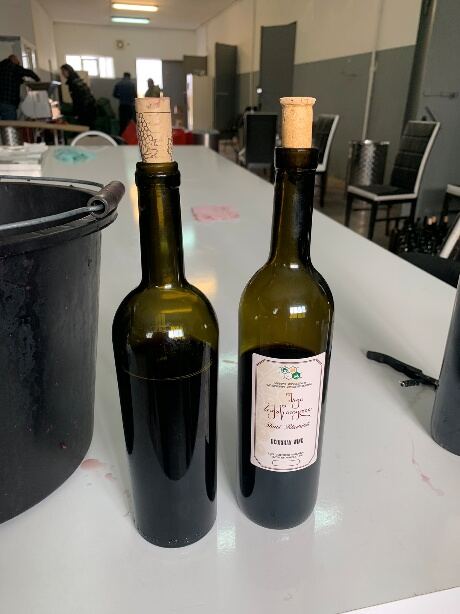 Two bottles of research wine samples on a table